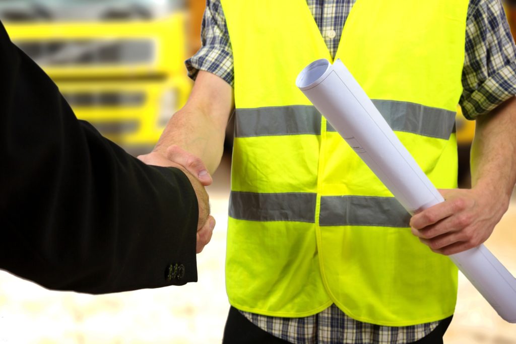 Construction worker's hand shaking hands.